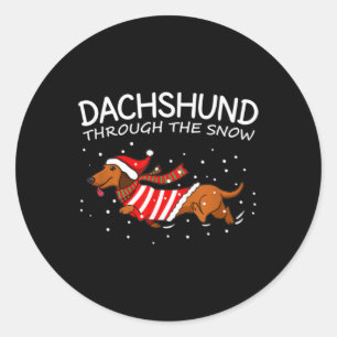 Sticker Rond Dachshund à travers la neige drôle chien Noël
