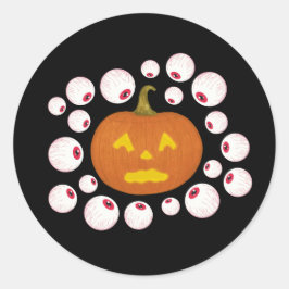 Sticker Rond Jack-o-Lantern Citrouille et les yeux dans l'obscu