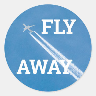 Sticker Rond L'avion vole dans le ciel bleu
