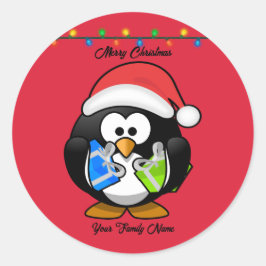 Sticker Rond Pingouin Arrière - plan rouge tenant des cadeaux d