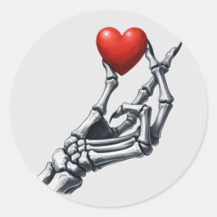 Sticker Rond Squelette levage main coeur rouge