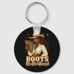 Stiefel auf der Erde Junetzehnte Cowgirl, wo sie Schlüsselanhänger