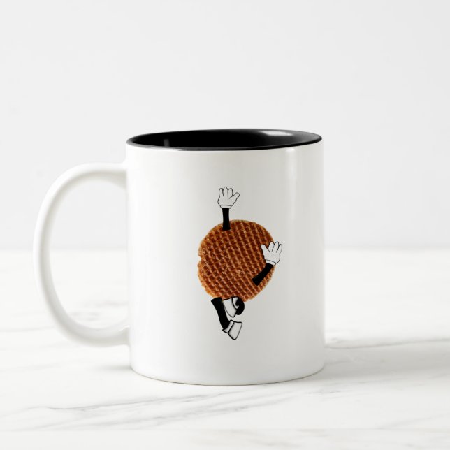 Stroopwafel springt vor Freude. Zweifarbige Tasse (Links)