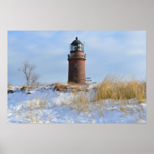Sturdy Lighthouse on a Rocky Coast in Winter Poster