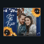 Sunflower Navy Blue Wedding Photo Save The Date Ankündigungspostkarte<br><div class="desc">Rustic navy blue and sunflower wedding photo save the date postcard featuring sunflowers and string lights on a barn wood background. Ideal card design for inviting your guest to your navy blue rustic country,  garden or barn wedding party inspired by sunflower flowers.</div>