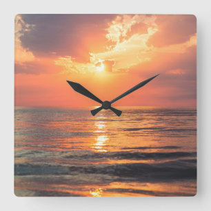 sunset over water quadratische wanduhr