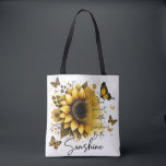 Sunshine Be the Sunshine | Tasche<br><div class="desc">This tote bag features a clean, modern design with a soft, uplifting aesthetic. The bag itself is white with sturdy black shoulder straps, creating a nice contrast that makes the artwork stand out. The front showcases a large, beautifully detailed sunflower in rich golden and amber tones, with layered petals and...</div>