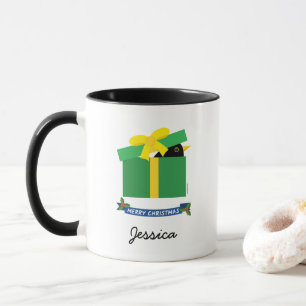 Süße Amsel schaut aus der Geschenkschachtel, benut Tasse