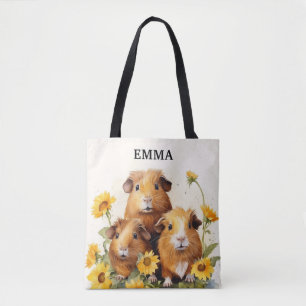 Süße entzückende Meerschweinchen mit Blumen und in Tasche
