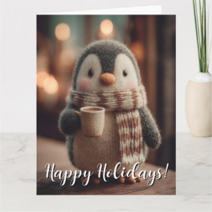 Süße gestrickte Pinguin-Puppe mit Schal und Tasse Karte
