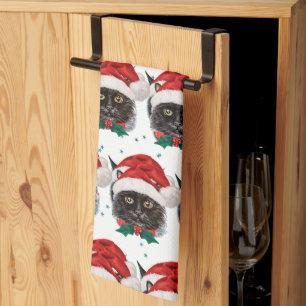 Süße schwarze Katze mit Weihnachtsmannmütze an Wei Geschirrtuch
