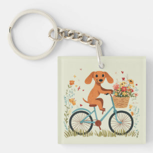 Süßer Dachshund Hund beim Radfahren mit Frühlingsb Schlüsselanhänger