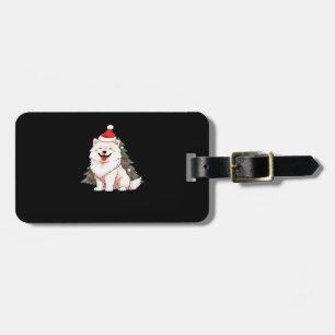Süßer Hund mit Weihnachtsmannmütze und Weihnachtsb Gepäckanhänger