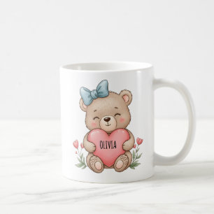 Süßer Teddybär hält rosa Herz Kaffeetasse
