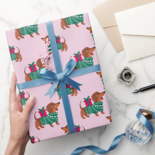 Süßer Weihnachts-Dachshund in grünem Pullover Rosa Geschenkpapier
