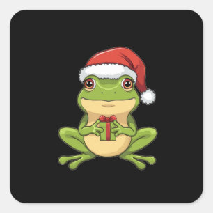 Süßer Weihnachtsfrosch mit Santa-Hut hält Geschenk Quadratischer Aufkleber