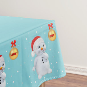 Süßer Weihnachtsmann und goldener Ball auf hellbla Tischdecke