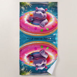 Süßes Nilpferd, das auf einem Donut-Schwimmbad-Sch Strandtuch