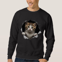 Süßes spähendes Tabby-Kätzchen zerrissenes Papier