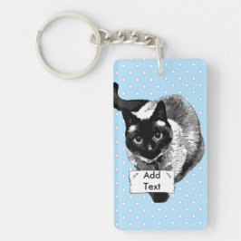 Sympathique chat siamois tenant un signe blanc