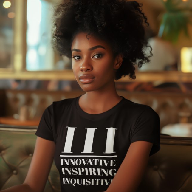 T-shirt III- Innovateur, Inspirant, Inquisiteur (Young black woman wears a "III: Innovative, Inspiring, Inquisitive" black t-shirt.)