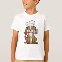 Le chien cuisinier avec le casquette et la spatule