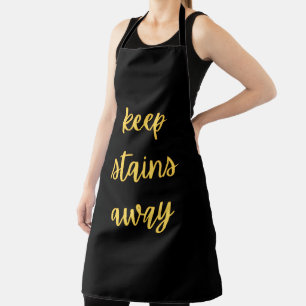 Tablier de cuisine noir et or "Éloigne les taches"