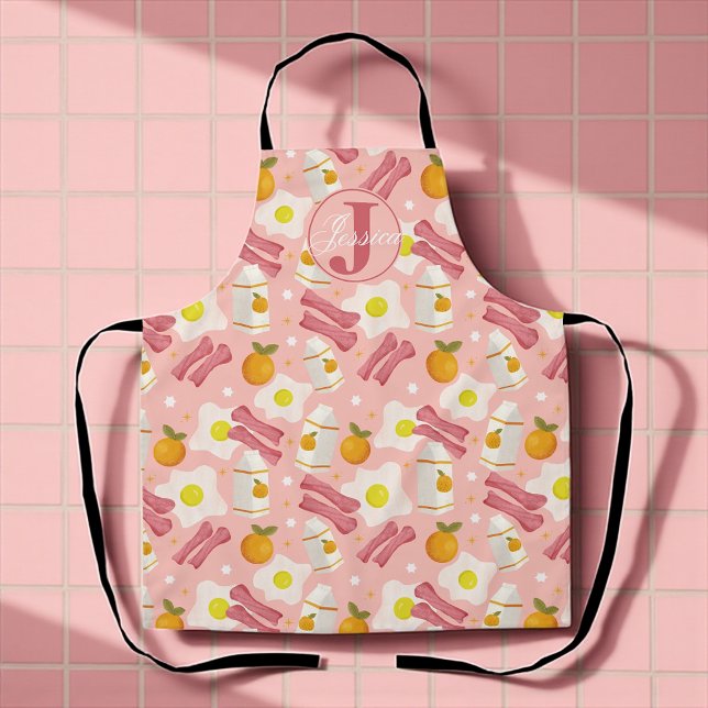 Tablier Motif de petit-déjeuner rétro personnalisé (Whimsical pink apron with fried eggs, bacon, milk, and oranges for sunny breakfast vibes.)