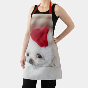 Tablier Un mignon chien blanc dans un Casquette de Noël ro