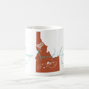 Tasse à la maison douce de maison d'état de