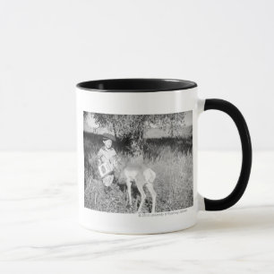 Tasse Antilope de alimentation de garçon à la main