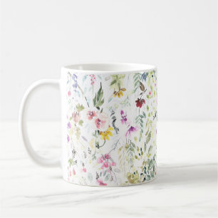 Tasse avec la fleur et les plantes peintes à la