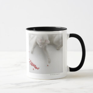 Tasse Chat jouant avec la sucrerie en forme de coeur
