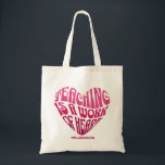 Teaching Is a Work of Heart Tragetasche<br><div class="desc">A bold and inspiring typography design featuring the phrase “Teaching Is a Work of Heart” arranged in a heart shape. The vibrant pink lettering and playful retro-style font create a warm and motivational design that celebrates the dedication and passion of teachers.</div>