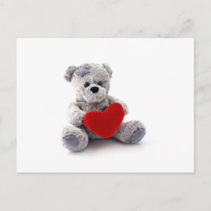 Teddy Bärenspielzeug, das ein Herz auf weißem Hint Postkarte