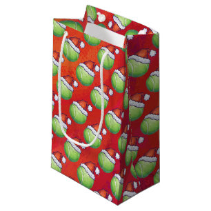 Tennisball in Weihnachtsmannmütze Muster auf Rot Kleine Geschenktüte