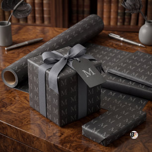 Texturiertes schwarzes Kunstleder mit Monogramm-Mu Geschenkpapier