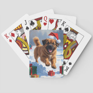 Tibet-Mastiff läuft im Schnee mit Weihnachtsmütze Spielkarten