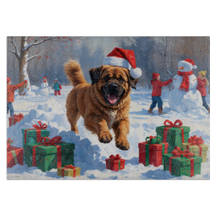 Tibetan Mastiff läuft mit Weihnachtsmut im Schnee Schneidebrett