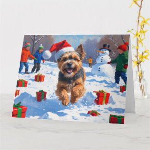 Tibetan Terrier läuft mit Weihnachtshut im Schnee Karte