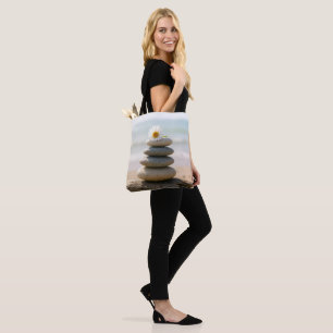 Tote Bag Pâquerette sur un cairn de plage en pierre avec bo