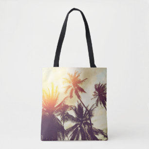 Tote Bag Tropical beach background with palm trees silhouet