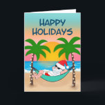 Tropical Beach Santa Hammock Palm Tree Feiertagskarte<br><div class="desc">Die Weihnachtskarte zum Thema Tropical und Küstenweihnachtszeit lädt zum Entspannen in einer Hängematte am Strand ein. Hier genießen Sie die Meereswellen und den bunten Sonnenuntergang und die festlichen Palmen, die in Strandlichter verziert sind. Cover Gruß sagt "Happy Holidays" in marineblau. Innen Gruß und der Name kann personalisiert sein (zeigt mit...</div>