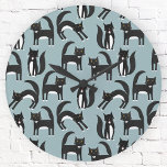 Tuxedo Black and White Cats Runde Wanduhr<br><div class="desc">Cute black and white tuxedo cats going about their business. A fun pattern on a mid blue background.</div>