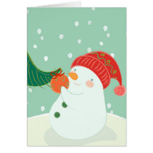 Un bonhomme de neige accrochant un ornement sur un
