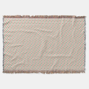 Une couverture tissée avec un point rouge et vert 