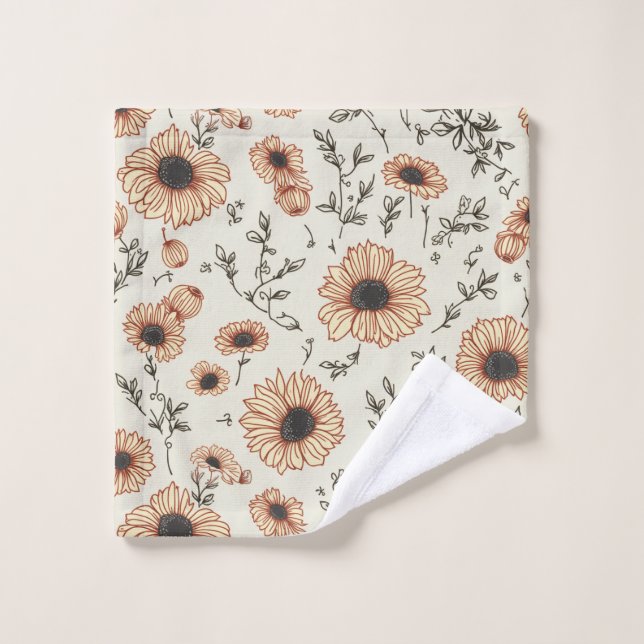 une serviette à fleurs jaune (Gant de toilette)