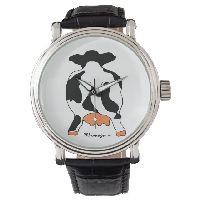 Vache noire et blanche derrière la montre (devant)