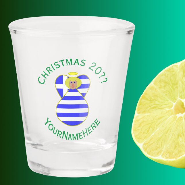 Verre A Shot Grec Blonde Angel Noël Drapeau Personnalisé (Christmas shot glas has blonde angel wearing Greek Flag. Green text for name, year, and holiday.)