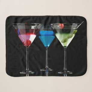 Verschiedene Cocktails in Martini-Brillen auf schw Sherpadecke